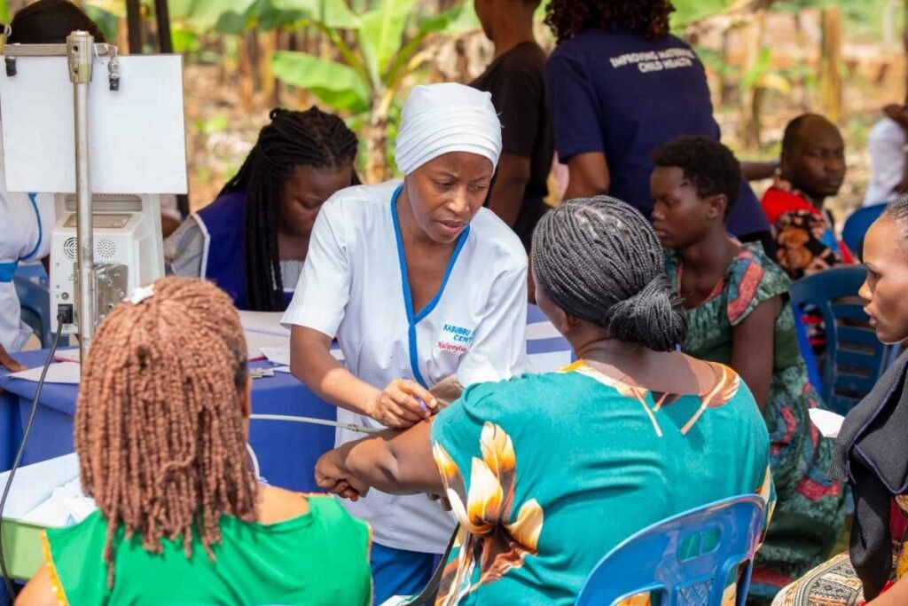 a nurse at kabubbu development project administering medicine to patient